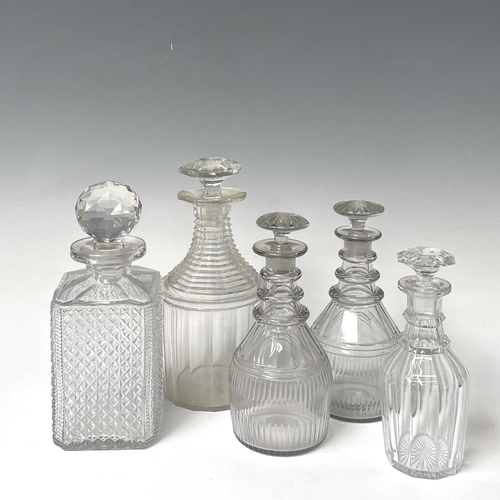 911 - A pair of Regency triple ring neck glass decanters and stoppers, with faceted and fluted decoration,... 