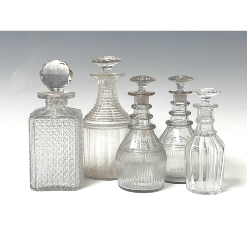 911 - A pair of Regency triple ring neck glass decanters and stoppers, with faceted and fluted decoration,... 