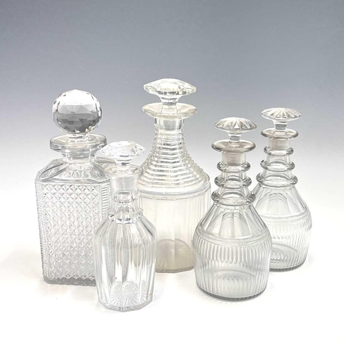 911 - A pair of Regency triple ring neck glass decanters and stoppers, with faceted and fluted decoration,... 