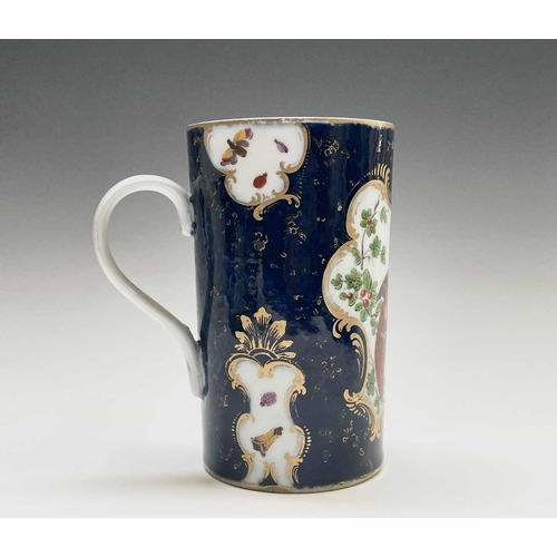 915 - A Continental porcelain mug, in the Worcester style, the blue scale ground with panels of an exotic ... 