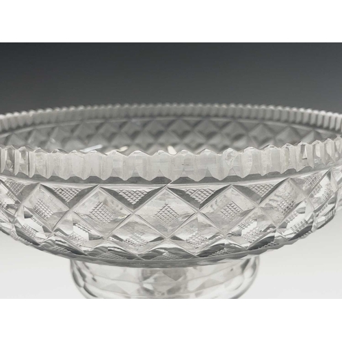 921 - A Georgian cut glass pedestal bowl, with serrated rim, hobnail cut lozenges and lemon squeezer base,... 