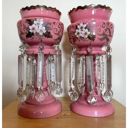 924 - A pair of Victorian pink opaque glass lustre vases, with floral painted and gilt decoration and cut ... 