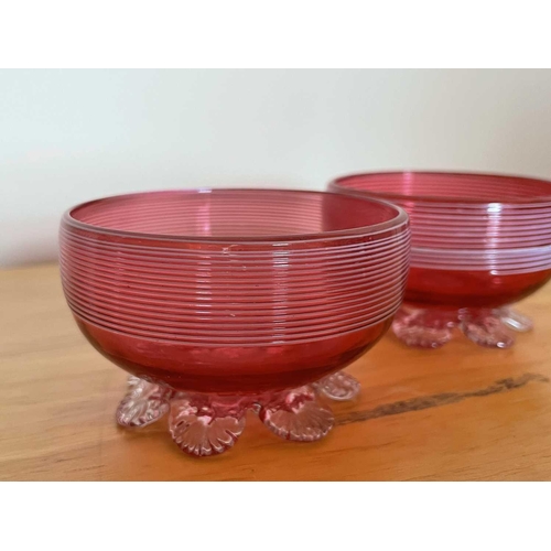 926 - A Victorian cranberry glass bowl with applied white trailing decoration, diameter 14cm, together wit... 