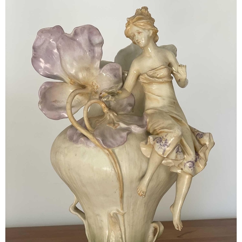 927 - A pair of Austrian Art Nouveau porcelain figural vases, moulded with seated females beside lilies an... 