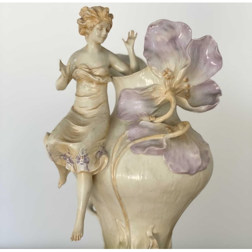 927 - A pair of Austrian Art Nouveau porcelain figural vases, moulded with seated females beside lilies an... 