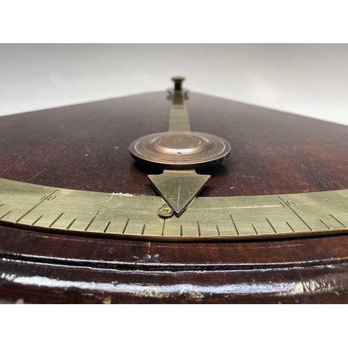 93 - A ship's brass inclinometer, 20th century, on a stained wood base, height 48.5cm.