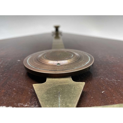 93 - A ship's brass inclinometer, 20th century, on a stained wood base, height 48.5cm.