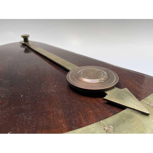 93 - A ship's brass inclinometer, 20th century, on a stained wood base, height 48.5cm.