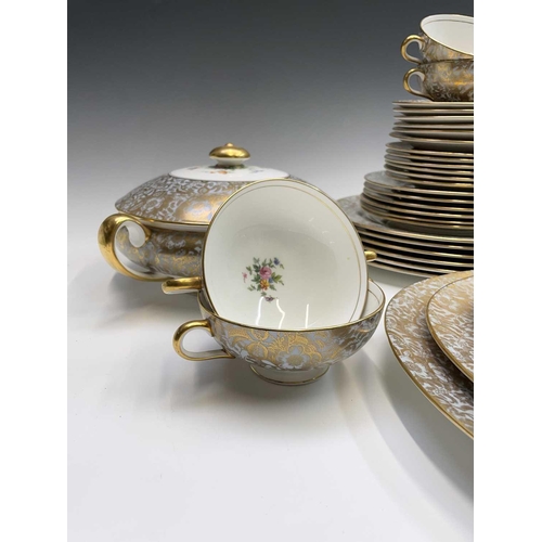 936 - A Minton dinner service, pattern no. H5066, floral design with gilded powder blue rim, comprising tw... 