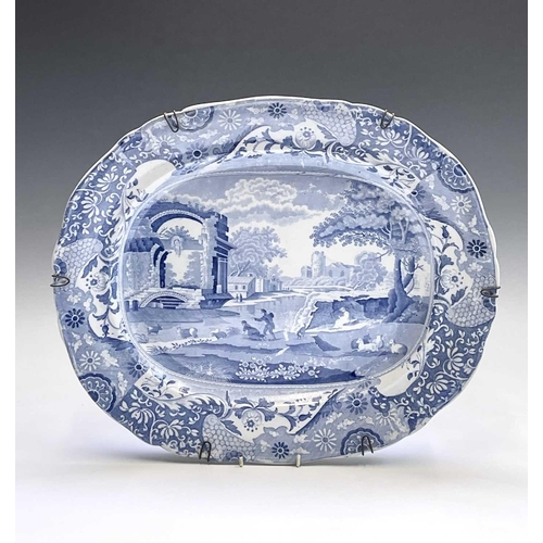 940 - A 19th century blue and white meat platter, printed with figures beside ruins, width 47cm, together ... 