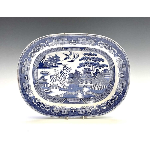 940 - A 19th century blue and white meat platter, printed with figures beside ruins, width 47cm, together ... 