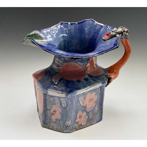 943 - Linda Styles, a contemporary studio pottery jug, with demonic mask handle and of typical misshapen f... 