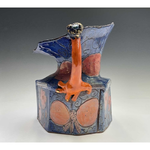 943 - Linda Styles, a contemporary studio pottery jug, with demonic mask handle and of typical misshapen f... 