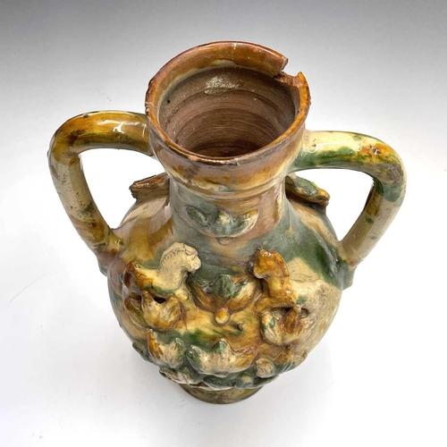 949 - A Continental pottery twin handled urn, probably Spanish, 18th/19th century, mounted with applied ho... 