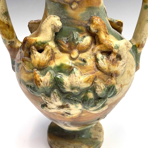 949 - A Continental pottery twin handled urn, probably Spanish, 18th/19th century, mounted with applied ho... 