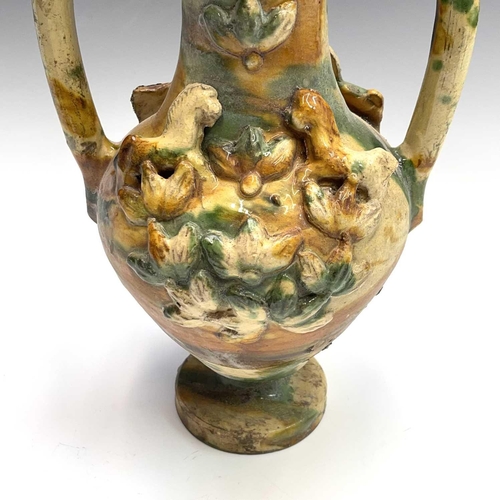 949 - A Continental pottery twin handled urn, probably Spanish, 18th/19th century, mounted with applied ho... 