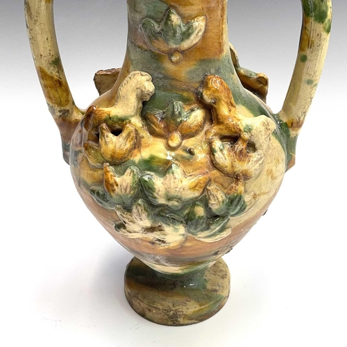 949 - A Continental pottery twin handled urn, probably Spanish, 18th/19th century, mounted with applied ho... 