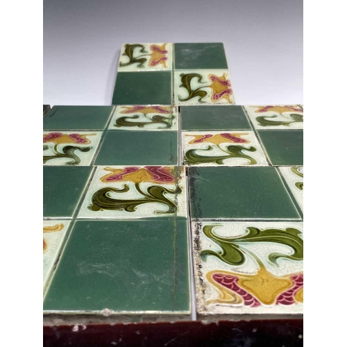 950 - Five Art Nouveau period tiles of square form decorated with stylized flowers, 15 x 15cm, three tiles... 