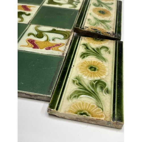 950 - Five Art Nouveau period tiles of square form decorated with stylized flowers, 15 x 15cm, three tiles... 