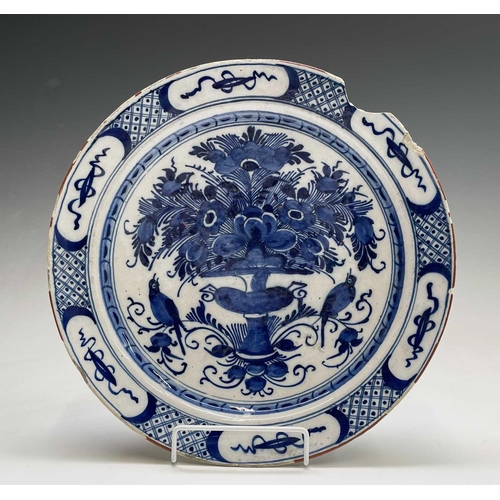 951 - A pair of 18th century Dutch blue and white delft plates, the centres decorated with a floral arrang... 