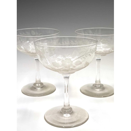 955 - A set of six Edwardian champagne coupes, the bowls with acid etched geometric decoration, a further ... 