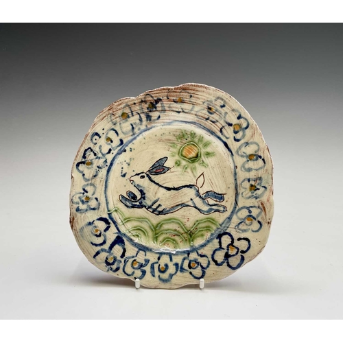 957 - A Ben Fosker (b.1960) slip decorated earthenware plate painted with a running hare, painted 'B' mark... 