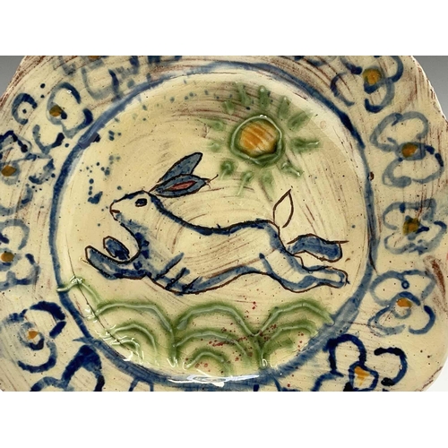 957 - A Ben Fosker (b.1960) slip decorated earthenware plate painted with a running hare, painted 'B' mark... 