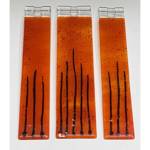 977 - Three studio glass panels, with streaked orange colouring, height 6.5cm (3).