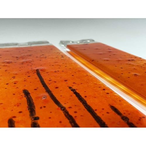 977 - Three studio glass panels, with streaked orange colouring, height 6.5cm (3).