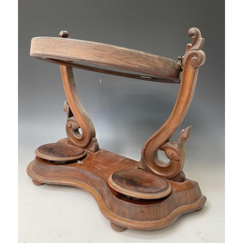 3045 - A Victorian mahogany swing toilet mirror, with oval plate, the base fitted two jewellery compartment... 