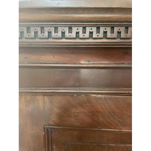 3187 - A George III mahogany linen press, the dentil cornice above a pair of cupboard doors enclosing trays... 