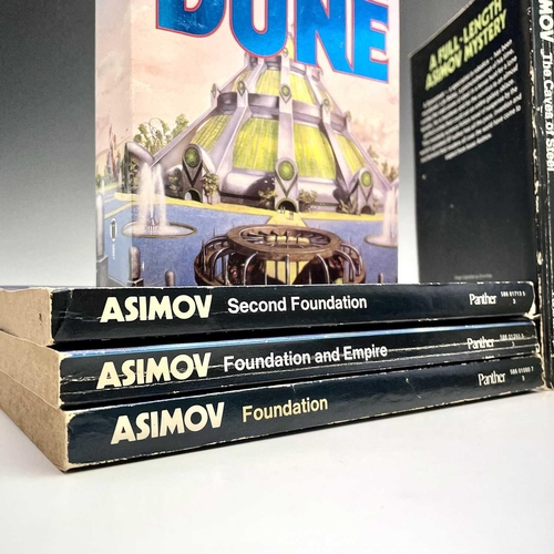 186 - SCIENCE FICTION. The Foundation trilogy by Isaac Asimov and Dune by Frank Herbert with classic cardb... 