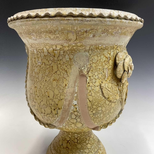 103 - A terracotta urn painted in stone effect, decorated with applied flowers and swags, with a painted p... 