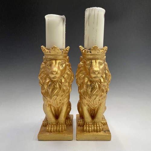 111 - Pair of gold painted lions with candles, height of lions 35cm.