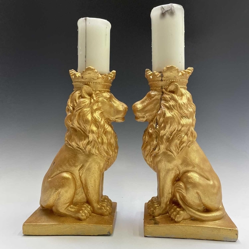 111 - Pair of gold painted lions with candles, height of lions 35cm.