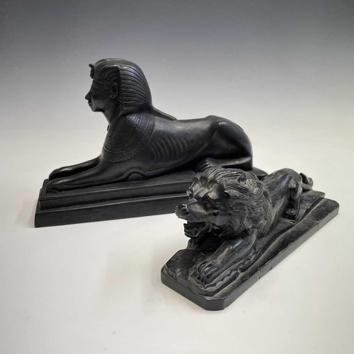 112 - A black onyx carved recumbent lion and a carved black stone sphinx, largest height 18cm width 29cm d... 