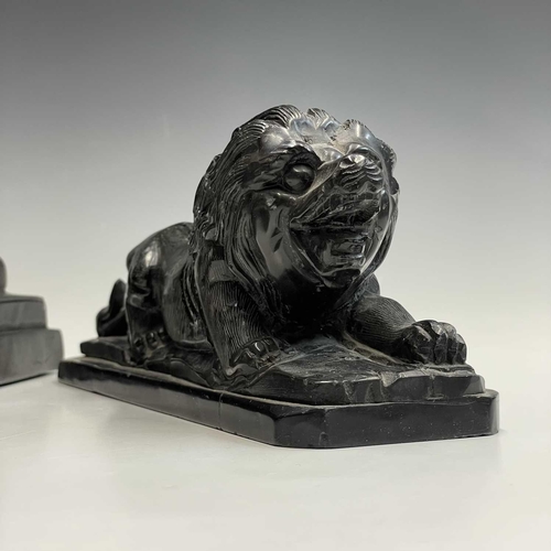 112 - A black onyx carved recumbent lion and a carved black stone sphinx, largest height 18cm width 29cm d... 