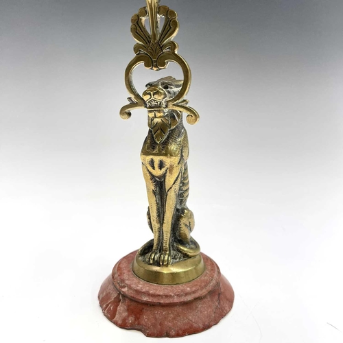 121 - A 19th century cast brass candlestick, the nozzle supported by a panther, height 20.5cm, together wi... 