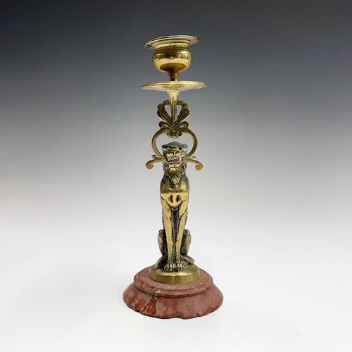 121 - A 19th century cast brass candlestick, the nozzle supported by a panther, height 20.5cm, together wi... 