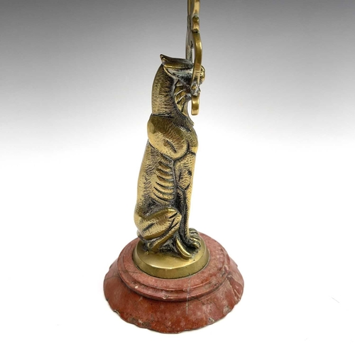 121 - A 19th century cast brass candlestick, the nozzle supported by a panther, height 20.5cm, together wi... 