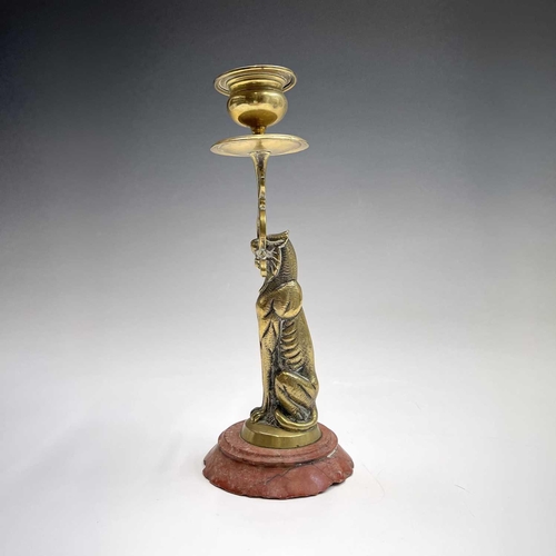 121 - A 19th century cast brass candlestick, the nozzle supported by a panther, height 20.5cm, together wi... 