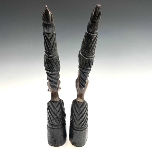 140 - A pair of central African heavy hardwood carved busts, as a male and female, height 38.5cm.