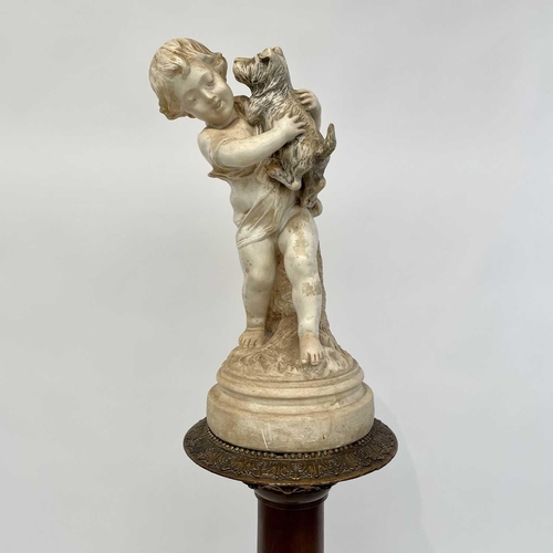 142 - A composite marble figure of a child and their dog, and a giltwood torchere decorated with shells an... 