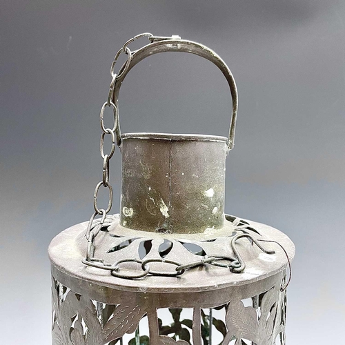 145 - A pierced brass hanging candle holder decorated with a floral design, height 50cm.