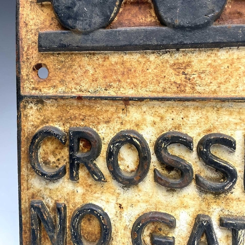 152 - A cast metal sign 'CROSSING NO GATES', 58cm x 29cm.