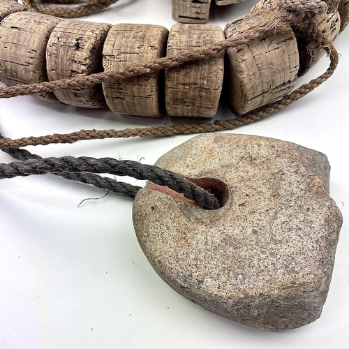 153 - Two strings of cork floats and stoneware end weights.