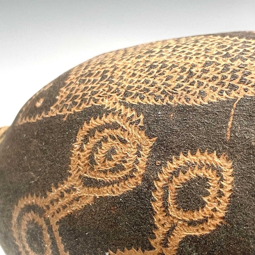 154 - An Australian Aboriginal carved boab nut the incised decoration depicting aquatic life including a c... 