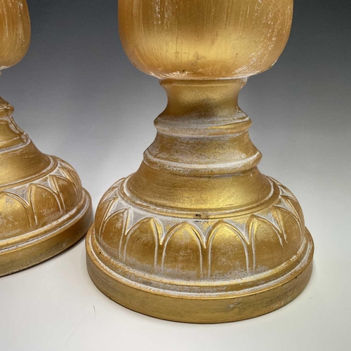 155 - A pair of candleholders decorated with acanthus leaf design, height 63cm.