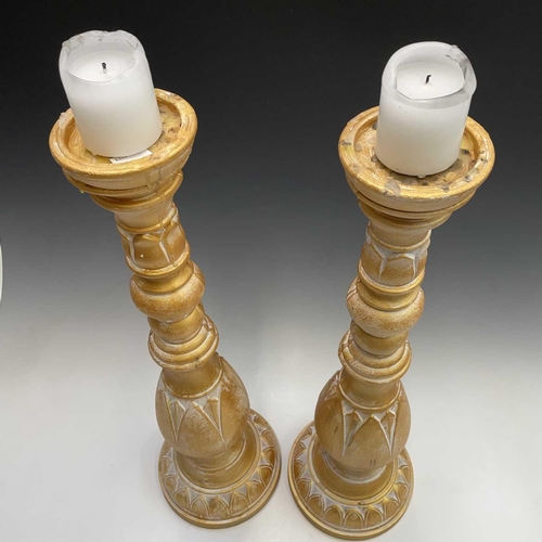 155 - A pair of candleholders decorated with acanthus leaf design, height 63cm.