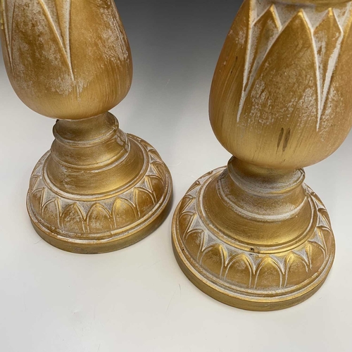 155 - A pair of candleholders decorated with acanthus leaf design, height 63cm.